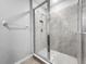 Shower with glass door, tile surround, built-in niche, and handheld shower head at 11946 Brighton Knoll Loop, Riverview, FL 33579