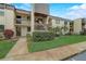Condo building exterior with a two-story design and landscaping at 2400 Winding Creek Blvd # 3-202, Clearwater, FL 33761