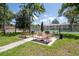 Community picnic area with grills and tables, near pool and tennis courts at 2400 Winding Creek Blvd # 3-202, Clearwater, FL 33761
