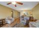Living room with hardwood floors, a ceiling fan, and comfortable seating at 2400 Winding Creek Blvd # 3-202, Clearwater, FL 33761