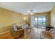 Living room with hardwood floors, sliding glass doors, and access to a patio at 2400 Winding Creek Blvd # 3-202, Clearwater, FL 33761