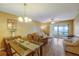 Bright dining area with wood table and access to balcony at 2400 Winding Creek Blvd # 3-202, Clearwater, FL 33761