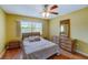 Cozy bedroom with double bed, dresser, and ceiling fan at 2400 Winding Creek Blvd # 3-202, Clearwater, FL 33761