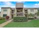 Condo building exterior featuring a two-story design and landscaping at 2400 Winding Creek Blvd # 3-202, Clearwater, FL 33761