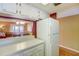Kitchen with white refrigerator and view to living room at 2400 Winding Creek Blvd # 3-202, Clearwater, FL 33761