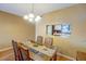 Dining room with kitchen pass-through and wood table at 2400 Winding Creek Blvd # 3-202, Clearwater, FL 33761