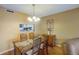 Dining room with kitchen pass-through and wood table at 2400 Winding Creek Blvd # 3-202, Clearwater, FL 33761