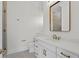 Clean bathroom with white vanity, quartz countertop, and a frameless shower at 96 Martinique Ave, Tampa, FL 33606