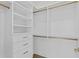 Bright walk-in closet with custom built-in shelves and rods at 96 Martinique Ave, Tampa, FL 33606