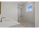 Modern bathroom with a walk-in shower and a window at 96 Martinique Ave, Tampa, FL 33606