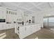 Modern white kitchen with large island and coffered ceiling at 96 Martinique Ave, Tampa, FL 33606
