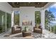 Relaxing outdoor patio with fireplace, wicker furniture, and stunning water views at 96 Martinique Ave, Tampa, FL 33606