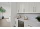 Stylish wet bar with white cabinets, quartz countertop at 96 Martinique Ave, Tampa, FL 33606