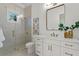 Modern bathroom with a glass shower, quartz countertop, and gold fixtures at 96 Martinique Ave, Tampa, FL 33606