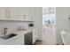 Modern wet bar with white cabinets and geometric tile at 96 Martinique Ave, Tampa, FL 33606