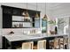 Modern bar with black cabinetry, quartz countertop and brass lighting at 96 Martinique Ave, Tampa, FL 33606