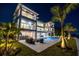 Back exterior view of a large house with a pool and patio at night at 96 Martinique Ave, Tampa, FL 33606