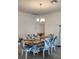 Elegant dining room with a modern chandelier and leaf-print chairs at 12351 Nouveau Ave, Spring Hill, FL 34610