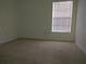 Simple carpeted bedroom with a window and blinds at 10319 Avelar Ridge Dr, Riverview, FL 33578
