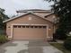 Two-story house with peach-colored siding and a two-car garage at 10319 Avelar Ridge Dr, Riverview, FL 33578