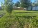 Backyard with lush green grass, fence, and an outdoor storage building at 1006 39Th W Ave, Bradenton, FL 34205
