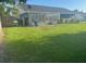 Backyard with lush green grass, fence, and an enclosed porch at 1006 39Th W Ave, Bradenton, FL 34205