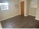 Bedroom featuring new flooring and window unit AC at 1006 39Th W Ave, Bradenton, FL 34205