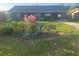 Charming single-story home featuring flowering shrubs in the front yard at 1006 39Th W Ave, Bradenton, FL 34205