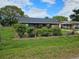Well-maintained single-story home featuring colorful flowering shrubs in a landscaped front yard at 1006 39Th W Ave, Bradenton, FL 34205