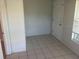 A room with a white door, tiled floor, and white door, offering a blank canvas for new owners at 1006 39Th W Ave, Bradenton, FL 34205