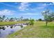 Beautiful canal view from the backyard of this property on a sunny day at 555 Rotonda Cir, Rotonda West, FL 33947