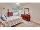 Inviting bedroom featuring two wooden dressers with vintage lamps and carpeted floors at 555 Rotonda Cir, Rotonda West, FL 33947