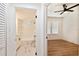 Clean bathroom with a white vanity and view into bedroom and bathroom at 3810 N Arlington Ave, Tampa, FL 33603
