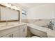 Updated bathroom with double vanity, marble tile, and a clawfoot tub at 3810 N Arlington Ave, Tampa, FL 33603