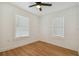 Bright bedroom with two windows, light walls, and wood-look flooring at 3810 N Arlington Ave, Tampa, FL 33603