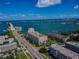 Aerial view of condo building near the water with bridge and waterway at 100 Bluff View Dr # 607A, Belleair Bluffs, FL 33770