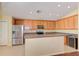 Kitchen boasts wood cabinets, stainless steel appliances, and an island at 422 Down Pine Dr, Seffner, FL 33584