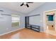 Bedroom with wood floors, built-in shelving, and ceiling fan at 422 Down Pine Dr, Seffner, FL 33584
