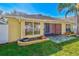 House exterior showcasing a screened patio and well-maintained landscaping at 422 Down Pine Dr, Seffner, FL 33584