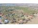 A panoramic overhead view of the property with a house, wooded area, and sprawling land at 8529 Kenton Rd, Wesley Chapel, FL 33545