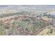 Beautiful aerial view of the expansive property surrounded by lush greenery and a community in the background at 8529 Kenton Rd, Wesley Chapel, FL 33545