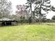 Large backyard with grass and mature trees at 8529 Kenton Rd, Wesley Chapel, FL 33545