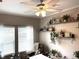 Bedroom area is adorned with shelves displaying decor, complemented by two windows that let in natural light at 8529 Kenton Rd, Wesley Chapel, FL 33545
