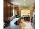 Traditional kitchen features tile floors, wooden cabinets, and an archway into the dining room at 8529 Kenton Rd, Wesley Chapel, FL 33545