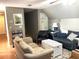 Cozy living room features two sofas, a wicker coffee table, and wood floors at 8529 Kenton Rd, Wesley Chapel, FL 33545
