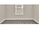 Simple bedroom with neutral walls and carpet, featuring a window with blinds at 3721 Wiggins Leaf St, Tampa, FL 33619