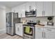 Modern kitchen with stainless steel appliances and white shaker cabinets at 3721 Wiggins Leaf St, Tampa, FL 33619