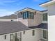 An exterior detail showcases stonework and dark-trimmed windows on the new construction at 4805 W San Rafael St, Tampa, FL 33629