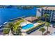 Aerial view of waterfront community, featuring a pool, tennis courts, and boat slips at 8251 Brent St # 912, Port Richey, FL 34668