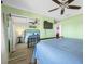 Bright bedroom with mirrored closet doors, a comfortable bed, and a ceiling fan at 8251 Brent St # 912, Port Richey, FL 34668